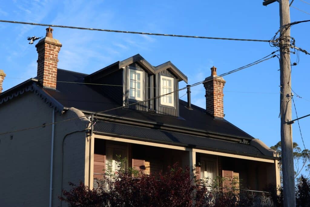 Exterior of a modern suburban home with clean architectural lines and a manicured front lawn, showcasing desirable curb ap...
