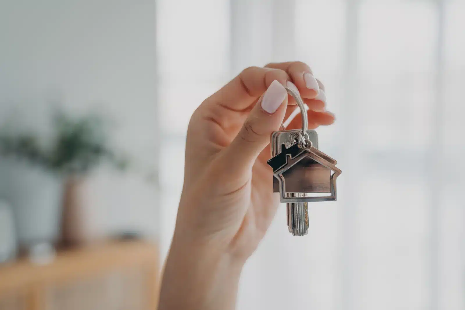 Woman-holds-house-keys--symbolizing-new-home-1766998696995.webp