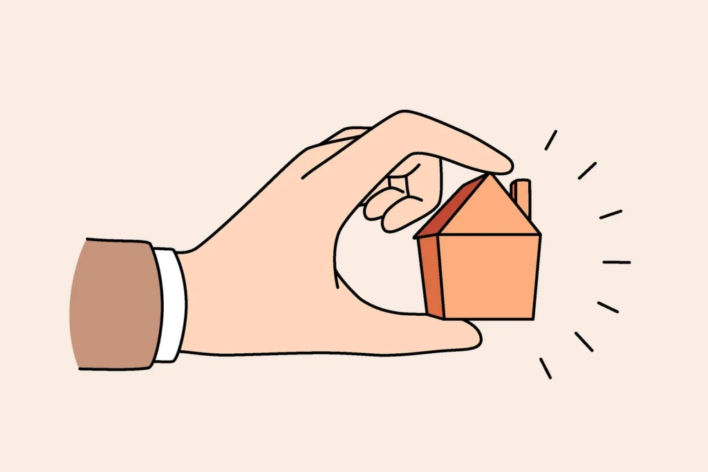 Human hand holding little tine house