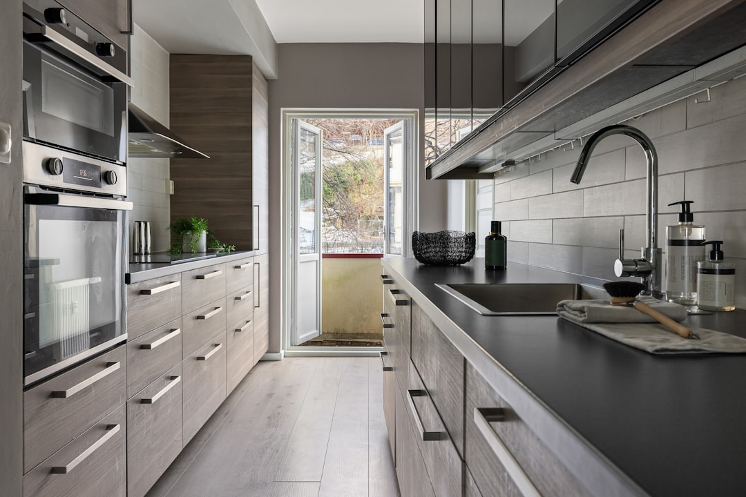 A close-up shot of a set of house keys resting on a professional architectural blueprint, signifying a successful real estate transaction and homeownership.