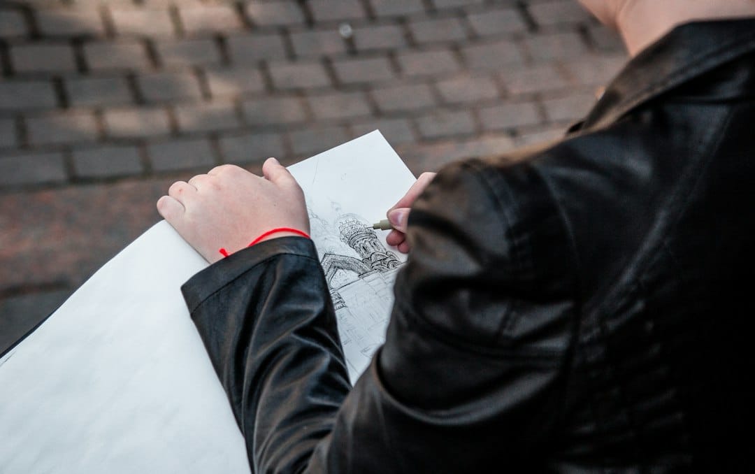 A close-up of an architect's hands drafting a modern house blueprint, symbolizing the strategic and successful 'Northshore Blueprint' model.