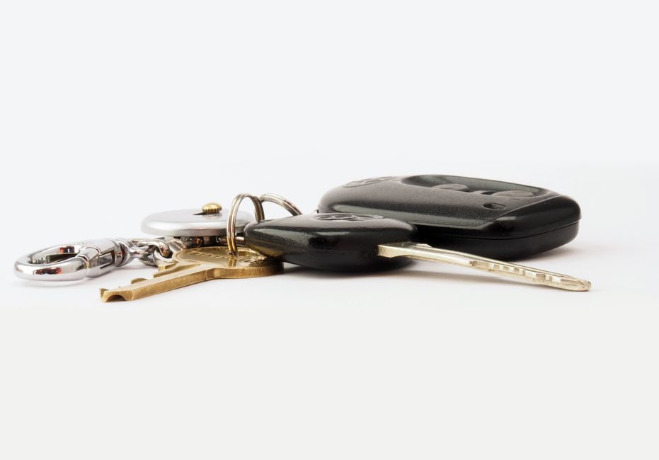 Heavy, rustic boat anchor lies on a wooden surface next to a set of modern house keys, visually representing the financial...