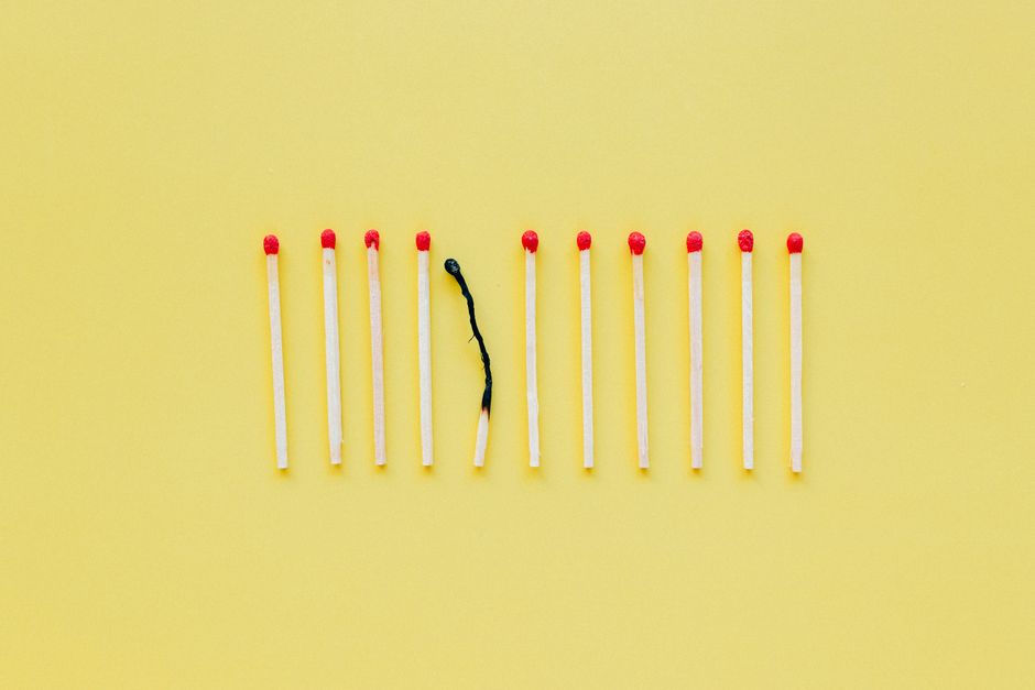 A single lit matchstick begins to ignite a long row of matches, a powerful visual metaphor for how one local idea sparked a national movement.