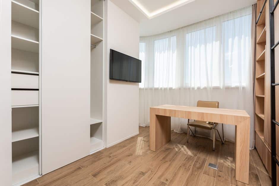 A bright and modern office interior with clean lines and minimalist furniture, representing the organized and efficient systems of a brokerage.