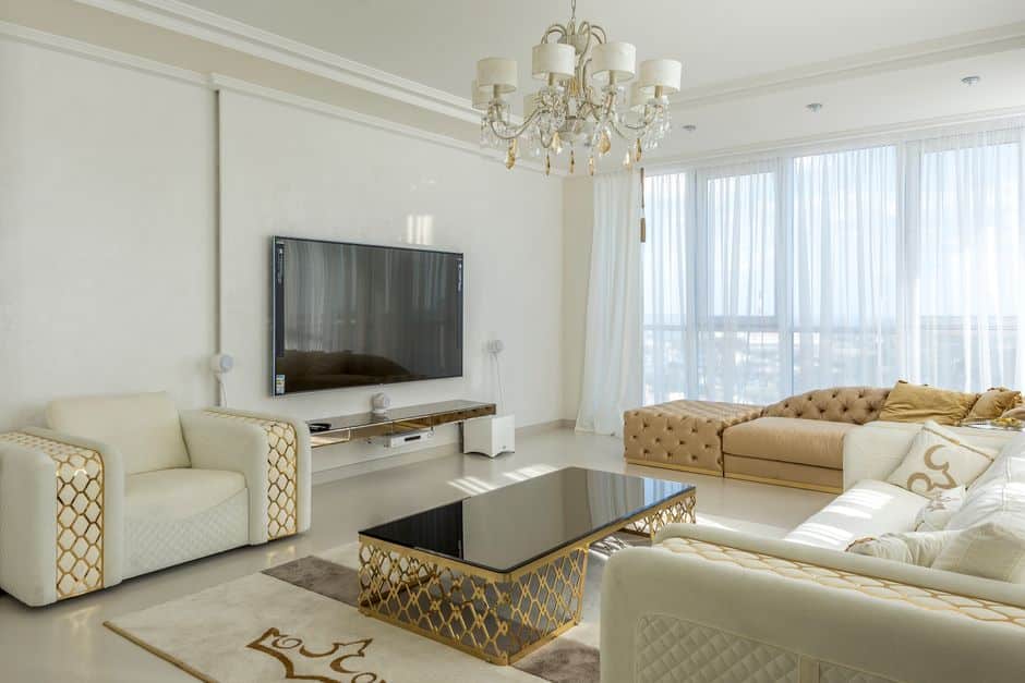 The sunlit interior of a bright, modern, and luxurious living room with high-end furniture, illustrating the concept of valuable home equity and financial success.