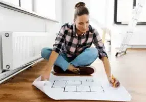 Person on floor with layout