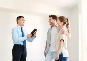 Real-estate--mortgage--technology-and-people-concept---happy-couple-and-realtor-with-tablet-pc-computer-at-new-home--coupl...