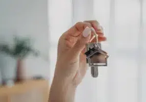 Woman-holds-house-keys--symbolizing-new-home-1766998696995.webp
